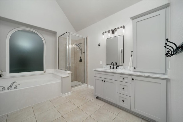 103 Sierra Ridge Dr, San Marcos, TX 78666 - full bathroom featuring tile patterned flooring, vanity, a shower stall, vaulted ceiling, and a garden tub