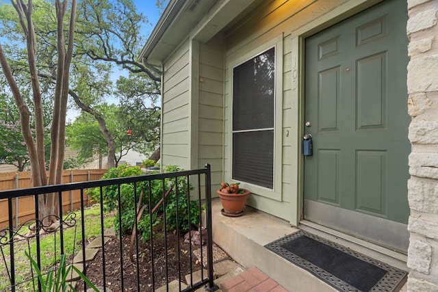 view of exterior entry with fence