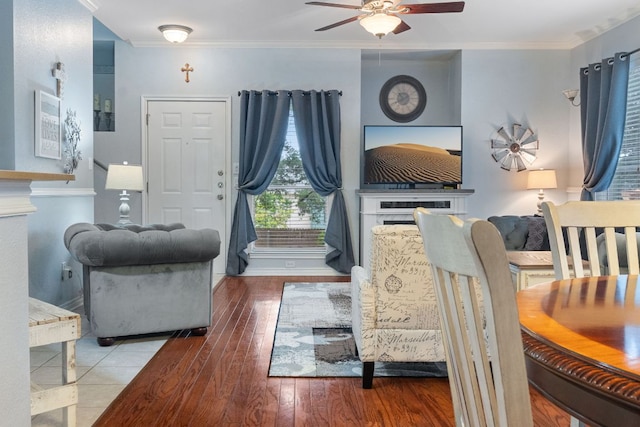 living room featuring crown molding, baseboards, ceiling fan, and hardwood / wood-style floors