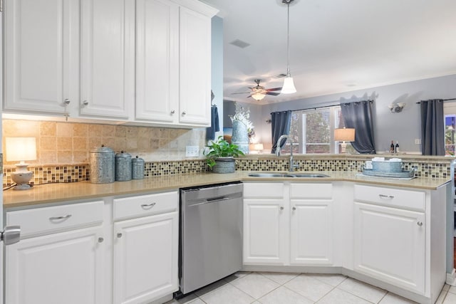 kitchen featuring a peninsula, ceiling fan, tasteful backsplash, a sink, and dishwasher