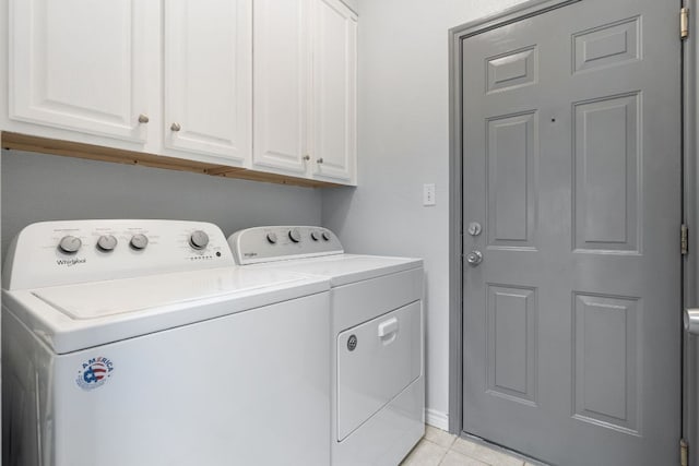 washroom featuring cabinet space, separate washer and dryer, and light tile patterned floors