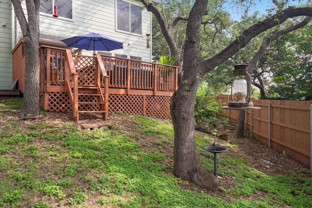 view of yard with fence and a deck