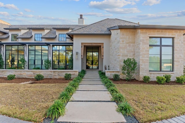 229 Tiffanie Way, Austin, TX 78737 - view of front facade featuring stucco siding, a chimney, a front lawn, and stone siding