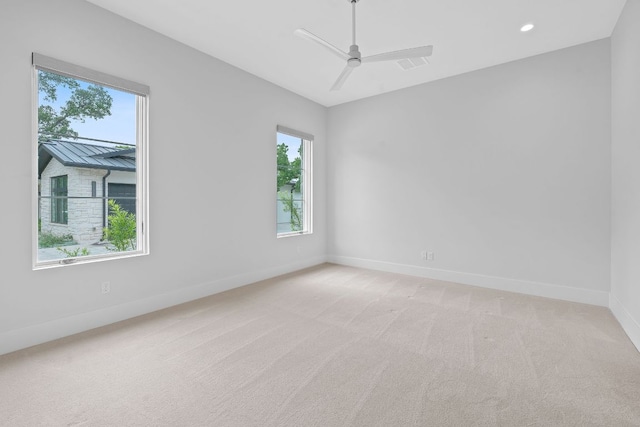 229 Tiffanie Way, Austin, TX 78737 - spare room with a healthy amount of sunlight, baseboards, a ceiling fan, and light colored carpet
