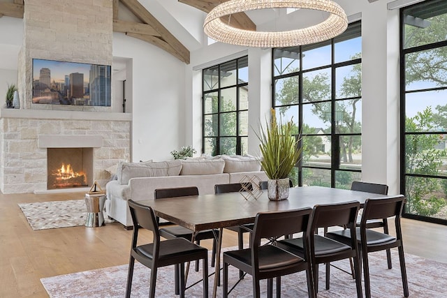 229 Tiffanie Way, Austin, TX 78737 - dining space featuring light wood-type flooring, plenty of natural light, and a towering ceiling