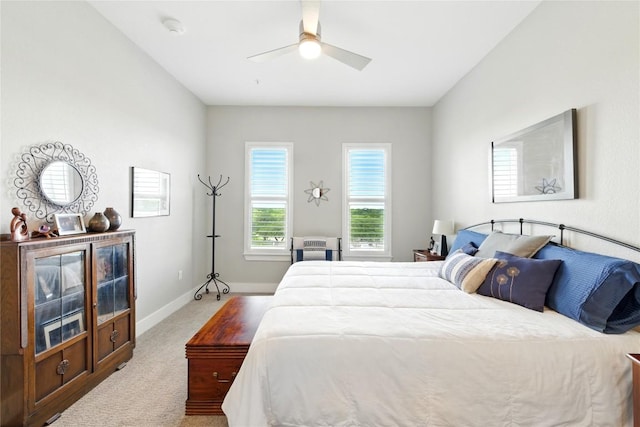 carpeted bedroom with baseboards and a ceiling fan