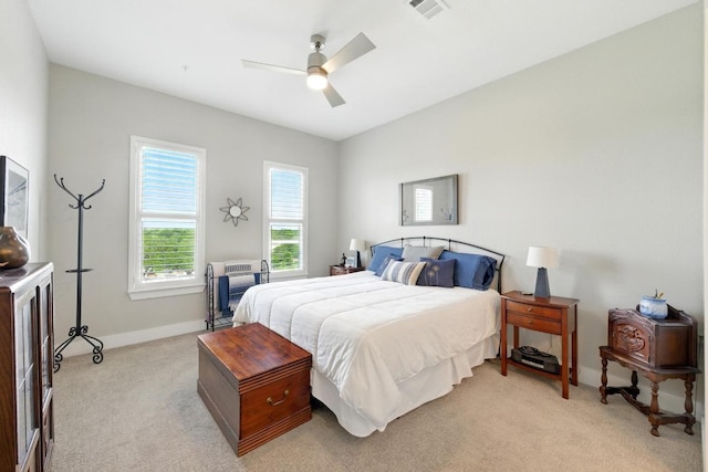 bedroom featuring light colored carpet, baseboards, ceiling fan, and visible vents