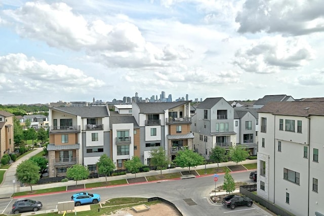 view of building exterior featuring a residential view and uncovered parking