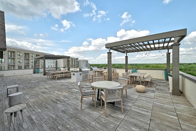 view of patio / terrace with exterior kitchen, outdoor dining space, a pergola, and a grill