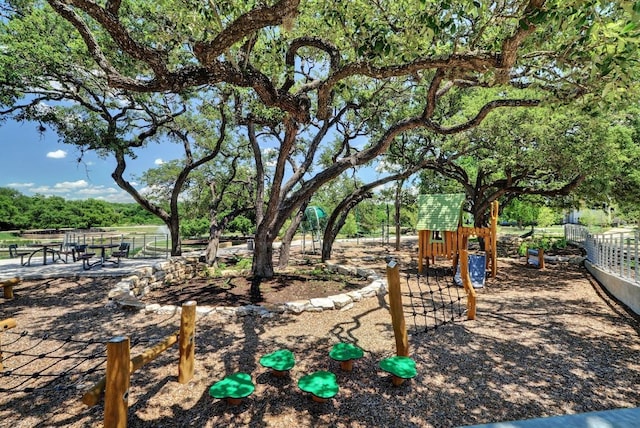 view of yard featuring fence and playground community
