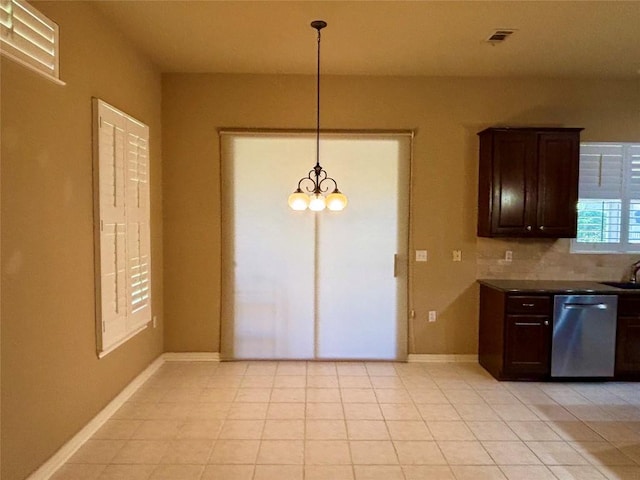 196 Whispering Wind Dr, Georgetown, TX 78633 - kitchen featuring dishwasher, dark brown cabinets, backsplash, dark countertops, and a chandelier
