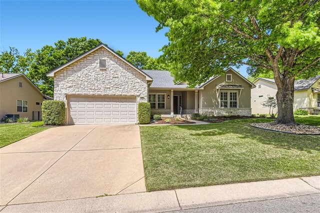196 Whispering Wind Dr, Georgetown, TX 78633 - ranch-style house with stone siding, driveway, an attached garage, and a front yard