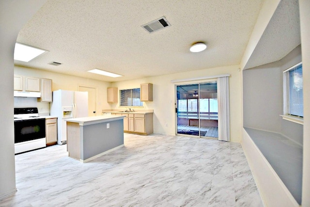 1411 Baffin Cv, Round Rock, TX 78664 - kitchen with electric range, a sink, white fridge with ice dispenser, under cabinet range hood, and visible vents