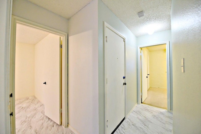 1411 Baffin Cv, Round Rock, TX 78664 - hall featuring a textured ceiling