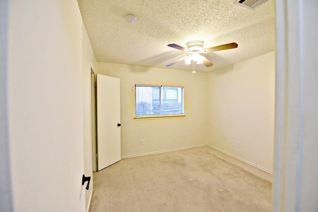 1411 Baffin Cv, Round Rock, TX 78664 - unfurnished room featuring visible vents, light carpet, baseboards, a textured ceiling, and a ceiling fan