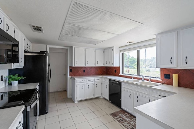 kitchen featuring a sink, light countertops, light tile patterned floors, visible vents, and black appliances