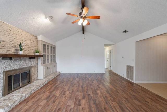 unfurnished living room with visible vents, a ceiling fan, a textured ceiling, and a fireplace