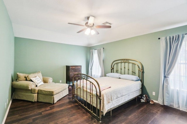 bedroom featuring baseboards, ceiling fan, wood finished floors, and visible vents