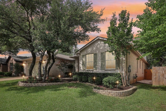 view of front facade with a garage, a front lawn, fence, and driveway