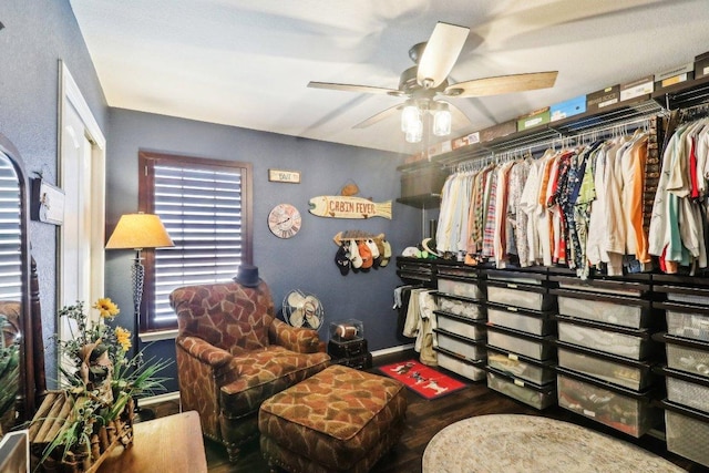 interior space featuring baseboards, ceiling fan, and wood finished floors