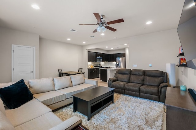 living room with visible vents, recessed lighting, and ceiling fan