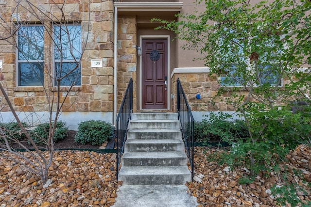 property entrance with stone siding