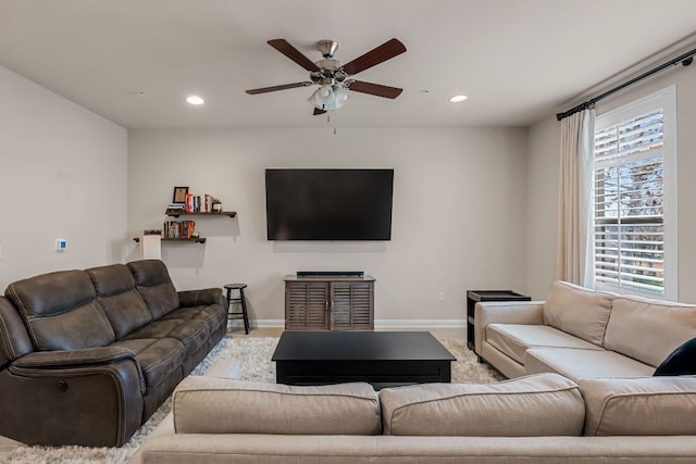 living room with baseboards, ceiling fan, light carpet, and recessed lighting