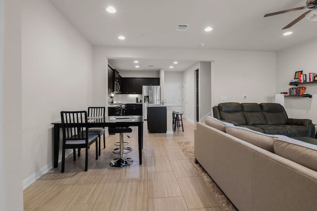 living area featuring recessed lighting, baseboards, ceiling fan, and visible vents