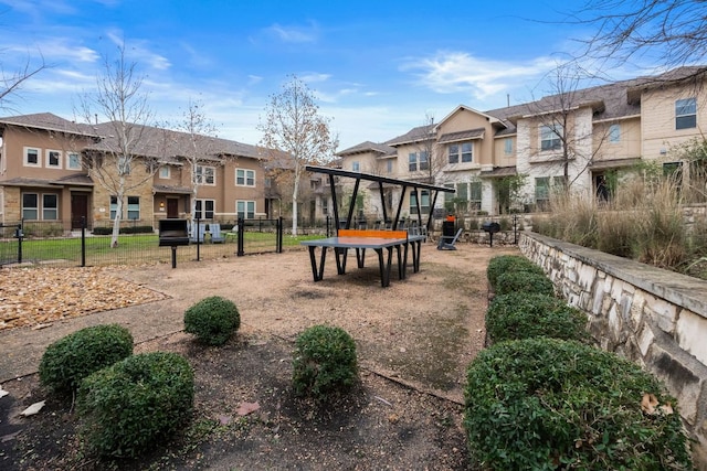 view of property's community with fence and a residential view