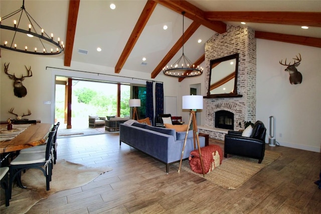 living room with high vaulted ceiling, a chandelier, beam ceiling, and wood finished floors