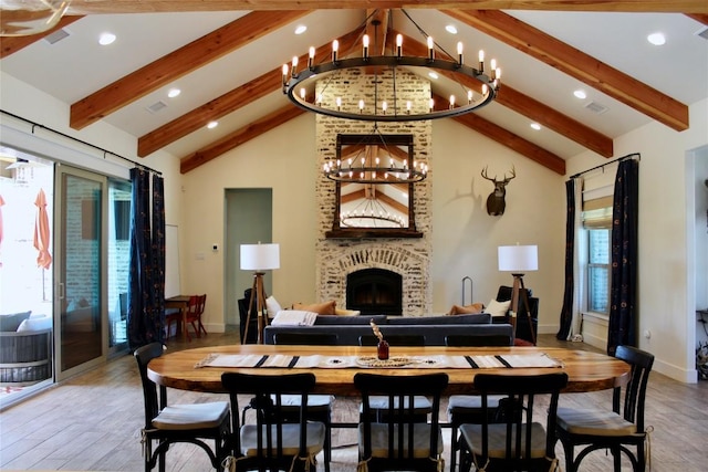 dining space with beam ceiling, an inviting chandelier, and wood finished floors