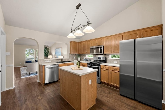 1777 Thompson Trl, Round Rock, TX 78664 - kitchen with stainless steel appliances, arched walkways, a sink, light countertops, and backsplash