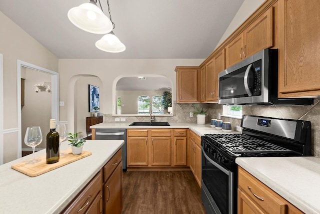 1777 Thompson Trl, Round Rock, TX 78664 - kitchen featuring decorative backsplash, dark wood-type flooring, light countertops, arched walkways, and stainless steel appliances