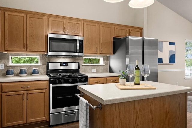 1777 Thompson Trl, Round Rock, TX 78664 - kitchen featuring a kitchen island, light countertops, brown cabinets, backsplash, and stainless steel appliances