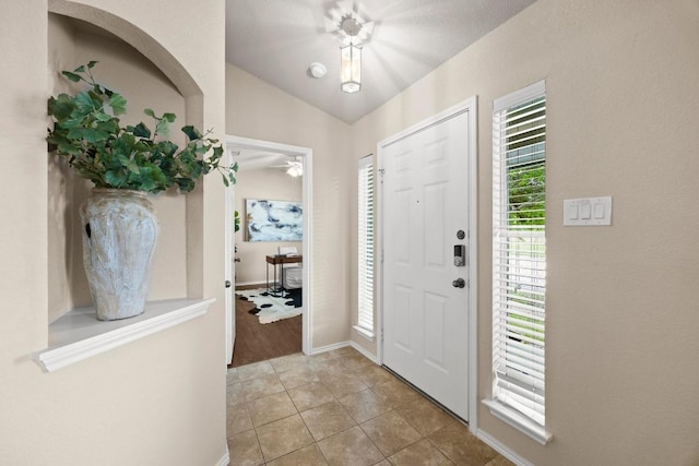 1777 Thompson Trl, Round Rock, TX 78664 - entryway featuring light tile patterned floors, vaulted ceiling, and a ceiling fan