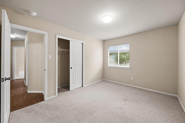 1777 Thompson Trl, Round Rock, TX 78664 - unfurnished bedroom featuring a closet, a textured ceiling, carpet, and baseboards