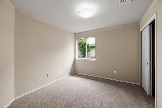 1777 Thompson Trl, Round Rock, TX 78664 - unfurnished bedroom with carpet floors, baseboards, a closet, and a textured ceiling