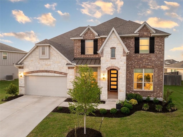 view of front facade with a garage, a shingled roof, a front yard, and concrete driveway