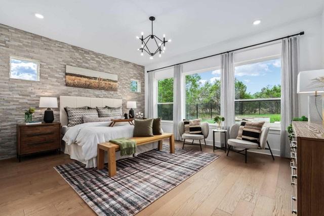 bedroom with recessed lighting, light wood-type flooring, and a chandelier