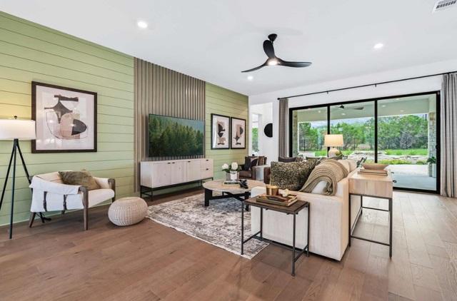living area with visible vents, wood finished floors, wooden walls, recessed lighting, and a ceiling fan