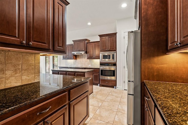 462 Shelf Rock, Driftwood, TX 78619 - kitchen featuring appliances with stainless steel finishes, tasteful backsplash, dark stone counters, dark brown cabinetry, and recessed lighting