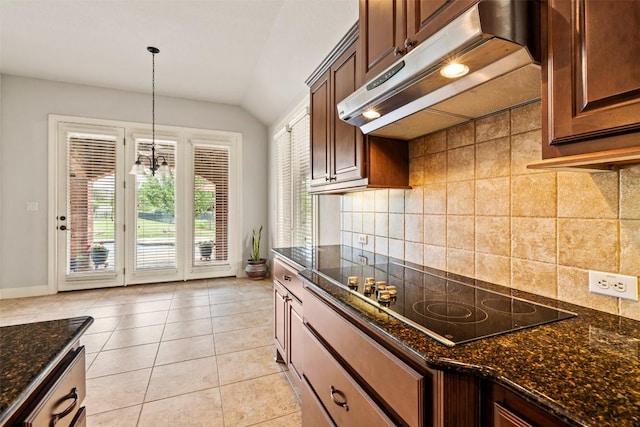 462 Shelf Rock, Driftwood, TX 78619 - kitchen featuring under cabinet range hood, black electric stovetop, vaulted ceiling, backsplash, and baseboards