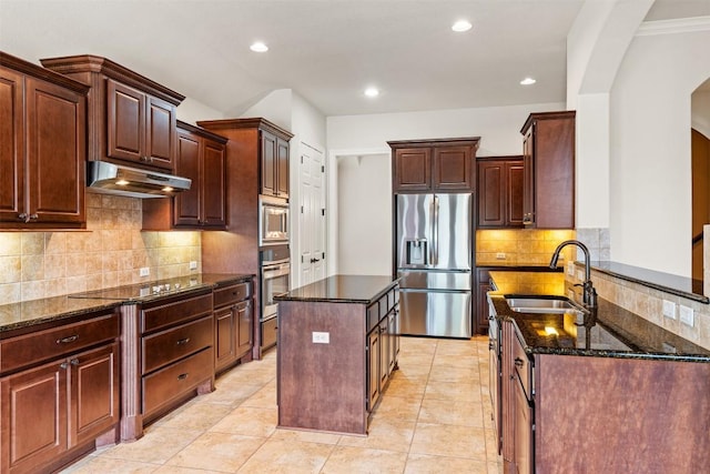 462 Shelf Rock, Driftwood, TX 78619 - kitchen with stainless steel appliances, under cabinet range hood, a sink, arched walkways, and dark stone counters