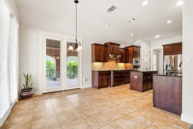 462 Shelf Rock, Driftwood, TX 78619 - kitchen with appliances with stainless steel finishes, under cabinet range hood, dark countertops, decorative backsplash, and a chandelier