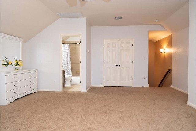 462 Shelf Rock, Driftwood, TX 78619 - unfurnished bedroom featuring vaulted ceiling, carpet flooring, connected bathroom, a closet, and baseboards