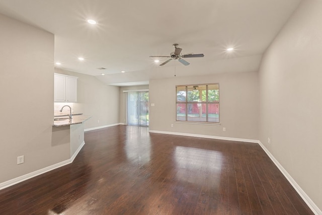 425 Valley Oaks Loop, Georgetown, TX 78626 - unfurnished living room with dark wood finished floors, baseboards, recessed lighting, a sink, and ceiling fan