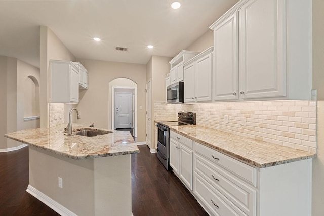 425 Valley Oaks Loop, Georgetown, TX 78626 - kitchen with appliances with stainless steel finishes, a sink, arched walkways, dark wood-style floors, and recessed lighting