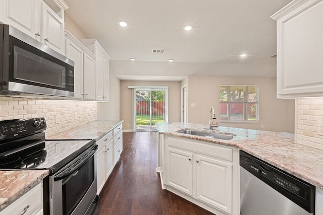 425 Valley Oaks Loop, Georgetown, TX 78626 - kitchen with stainless steel appliances, a sink, dark wood-style flooring, backsplash, and recessed lighting