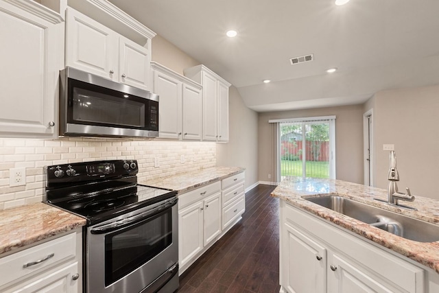 425 Valley Oaks Loop, Georgetown, TX 78626 - kitchen featuring appliances with stainless steel finishes, a sink, backsplash, white cabinets, and recessed lighting