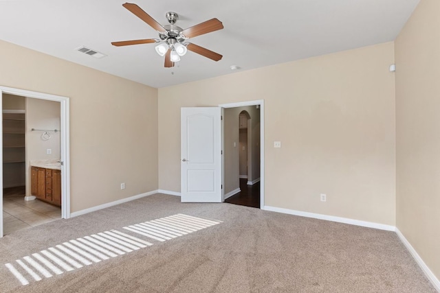 425 Valley Oaks Loop, Georgetown, TX 78626 - unfurnished bedroom with light carpet, baseboards, and connected bathroom